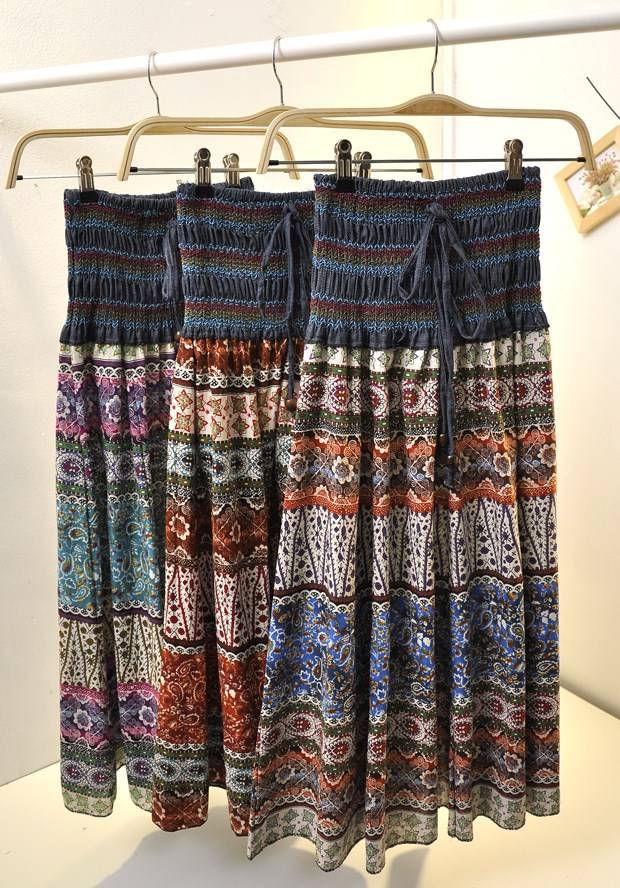 Three colorful Strapless Beach holiday Midi boho dresses hanging on a hanger, by Beachy Cover Ups.