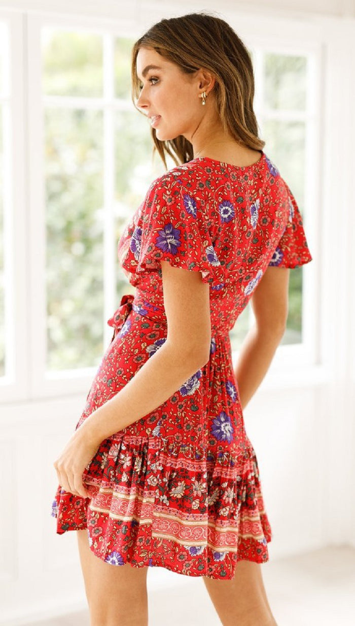 A versatile woman wearing a red floral print Beachy Side Wrap Summer Midi Dress by Beachy Cover Ups.