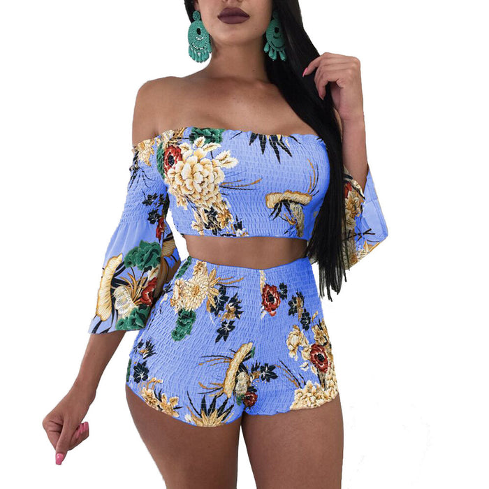 A woman in a Floral Stretch Fabric Two-piece Beach Set by Beachy Cover Ups featuring a blue floral print bikini.