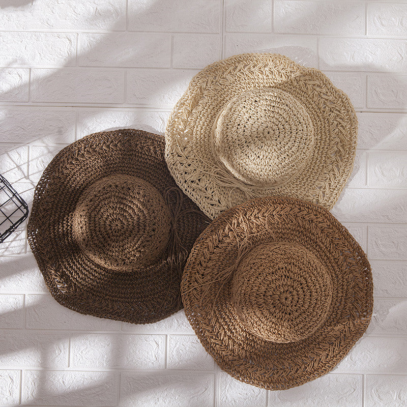 Three Foldable Seaside Beach Hats on a white brick wall by Beachy Cover Ups.