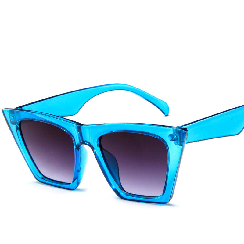 A pair of Trapezoid Retro Sunglasses by Beachy Cover Ups on a white background.