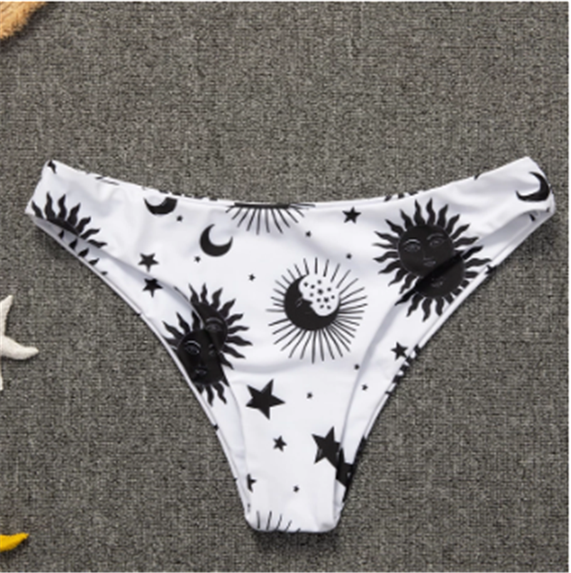 A pair of Astro Stars Sun And Moon Beach Bikini bottoms featuring stars and moons motifs, by Beachy Cover Ups.