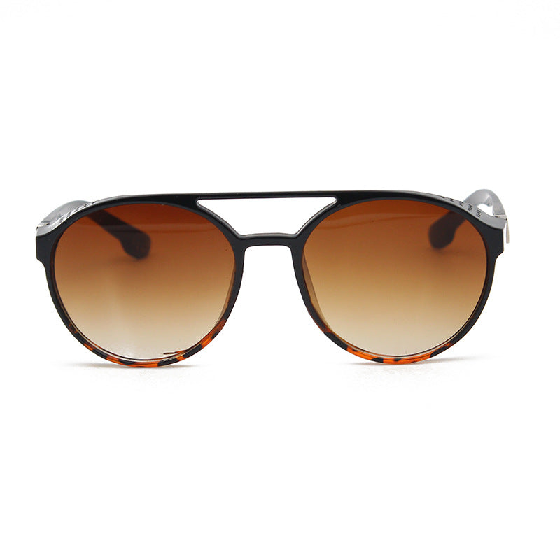 A pair of Beach Steampunk Sunglasses with tortoise lenses and a black frame, boasting vintage charm, by Beachy Cover Ups.