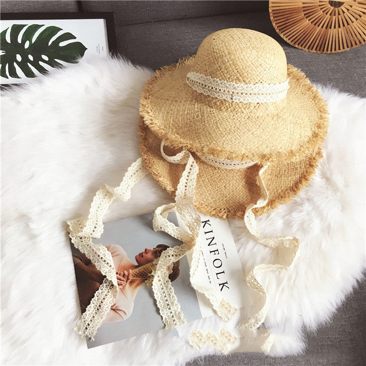 A Fringed Beach Raffia Ribbon straw hat with lace accents for sun protection as part of a Beachy Cover Ups beach ensemble.