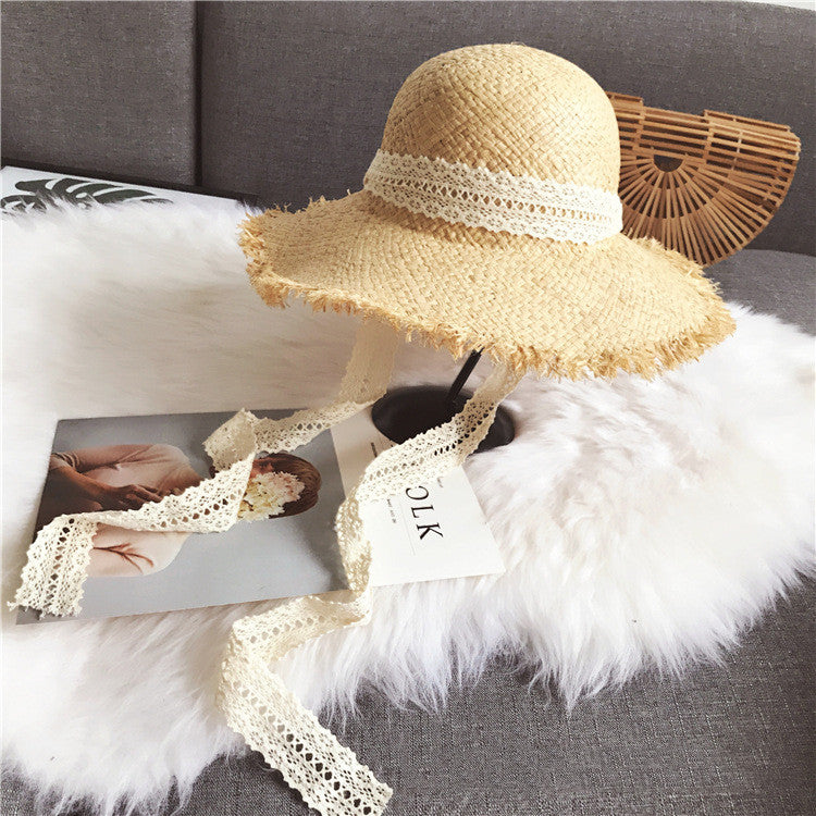 A Fringed Beach Raffia Ribbon straw hat by Beachy Cover Ups for beach ensemble and sun protection.