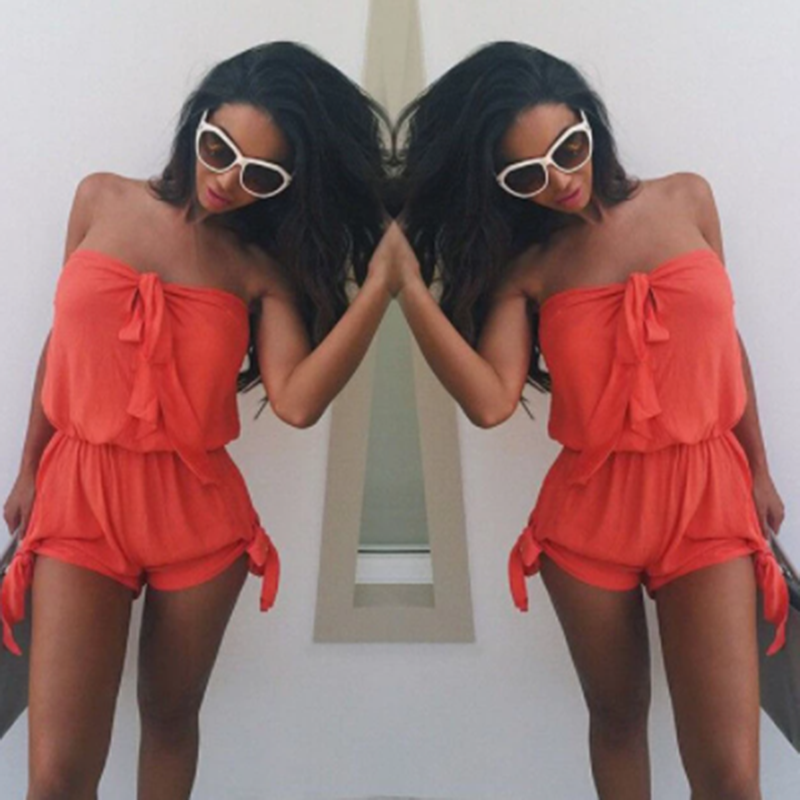 A woman wearing a Beachy Cover Ups Mini Romper Side Ties Summer Beach Dress and sunglasses.