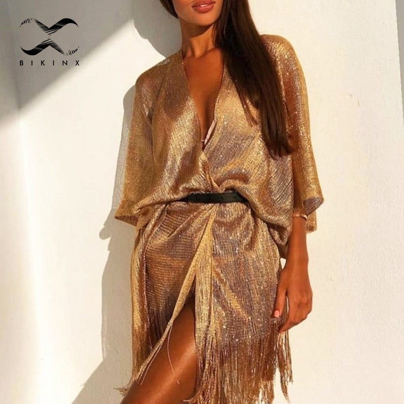 A woman is posing in a Gold Or Black Tassel Bikini Cover Up Beach Jacket from Beachy Cover Ups.