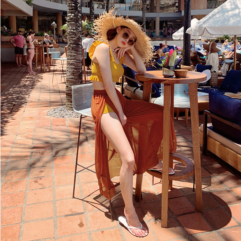 A woman in a Beachy Cover Ups beach hat sitting at a table.