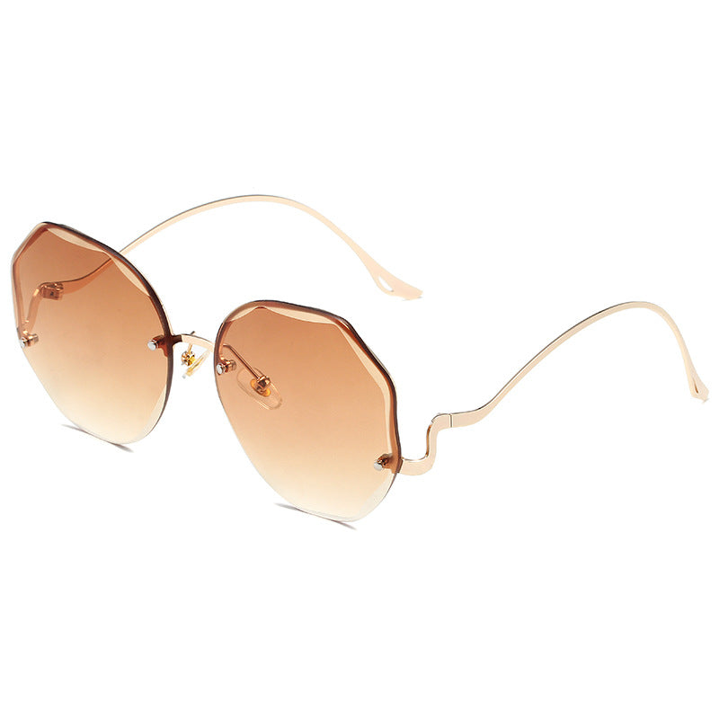 A pair of Beachy Cover Ups Irregular Shaped Rimless Cut Edge Sunglasses with a gold frame, featuring avant-garde style.