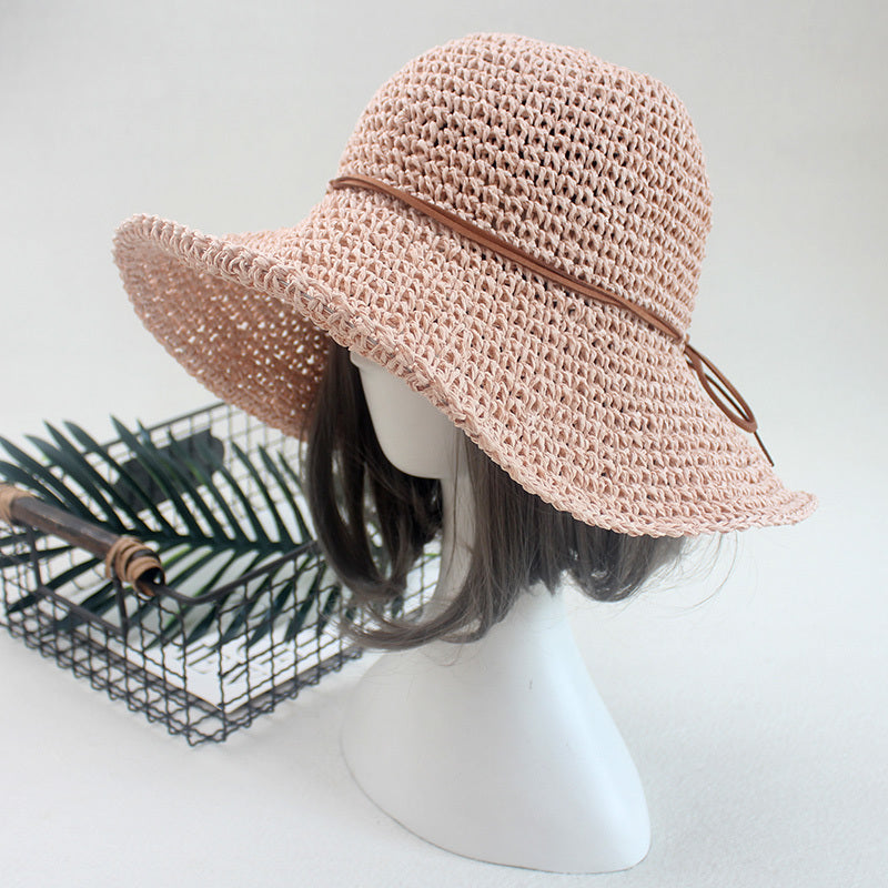 An Elegant Foldable Travel Beach Straw Hat by Beachy Cover Ups on a mannequin head.