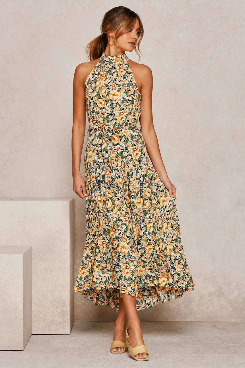 A woman wearing a yellow Floral Or Polka Halter long Dress With Front Ribbon Tie by Beachy Cover Ups.