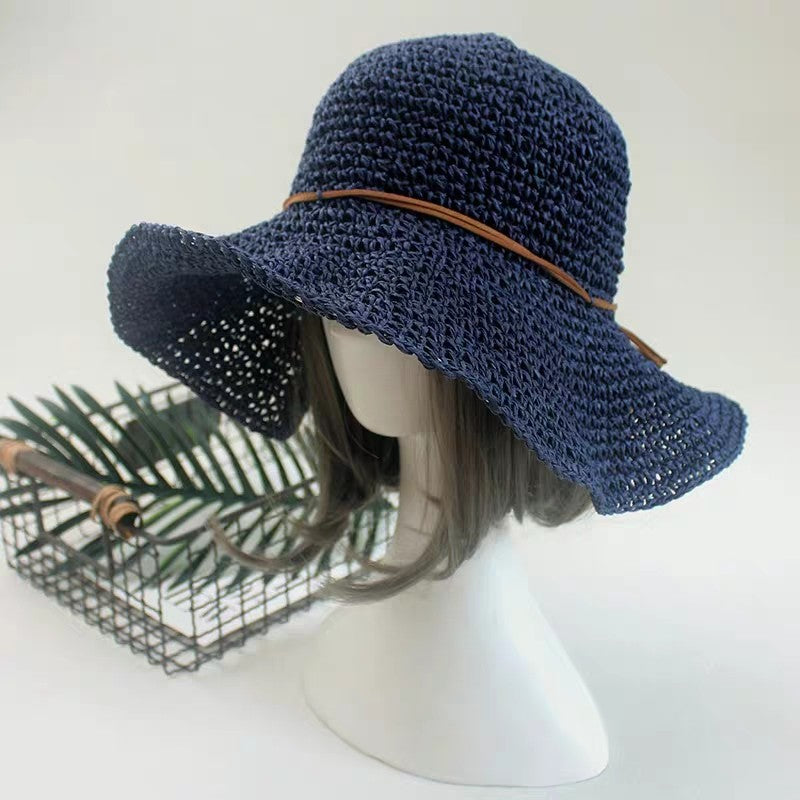 A mannequin wearing an Elegant Foldable Travel Beach Straw Hat by Beachy Cover Ups.