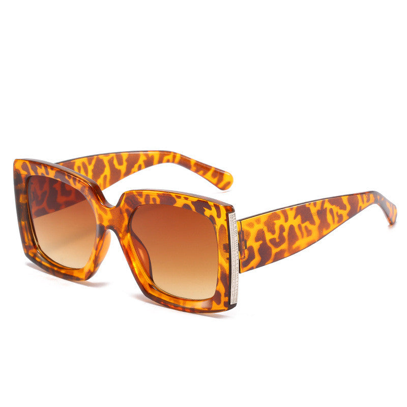 A pair of Trendy Large Frame Sunglasses by Beachy Cover Ups in leopard print on a white background.