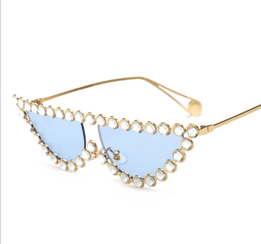 A pair of Beachy Cover Ups Studded Cat's Eye Sunglasses with vintage glamour featuring blue rhinestones and gold accents.