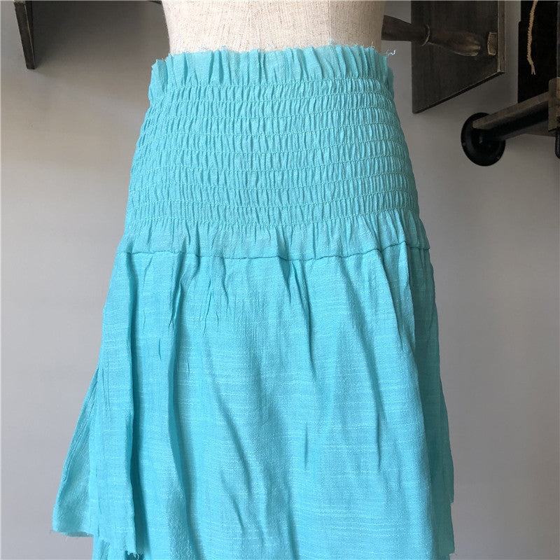 A turquoise fringed summer cotton beach shorts on a mannequin, from the brand Beachy Cover Ups.