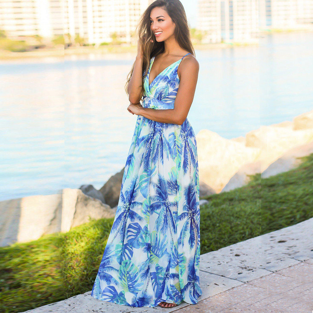 A woman in a Long Floral Resort Beach Dress by Beachy Cover Ups exuding tropical elegance.