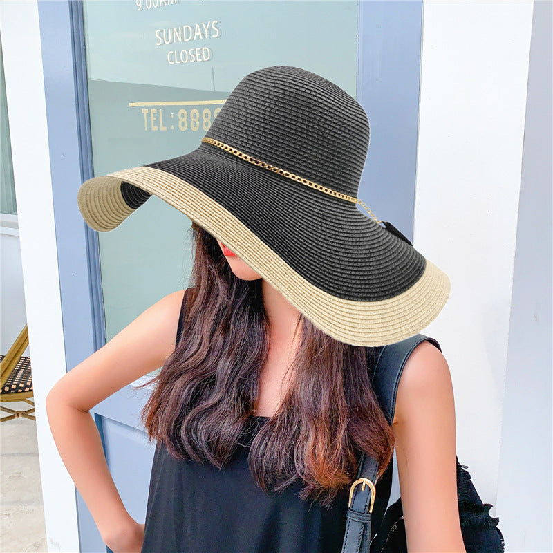 A woman wearing a Gold Chain Big Brim Beach Hat by Beachy Cover Ups.