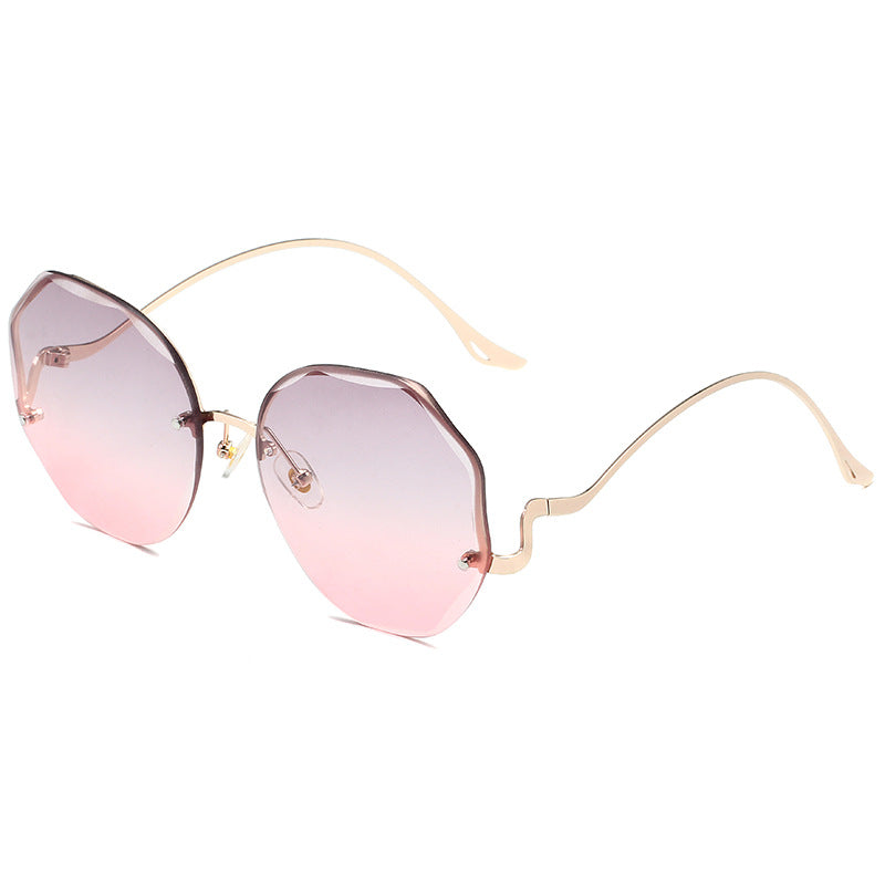 Beachy Cover Ups Irregular Shaped Rimless Cut Edge Sunglasses with a gold frame.