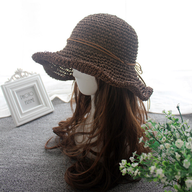 An Elegant Foldable Travel Beach Straw Hat from Beachy Cover Ups on a mannequin's head, perfect for beach sun-chasing adventures.