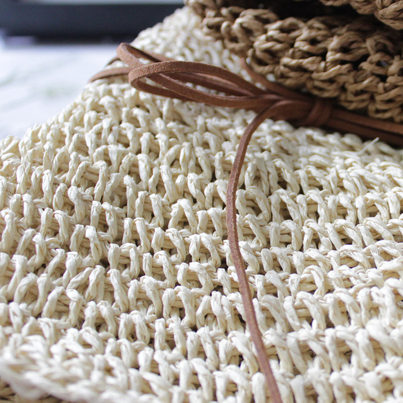 A stack of Beachy Cover Ups' Elegant Foldable Travel Beach Straw Hats ready for sun-chasing adventures.