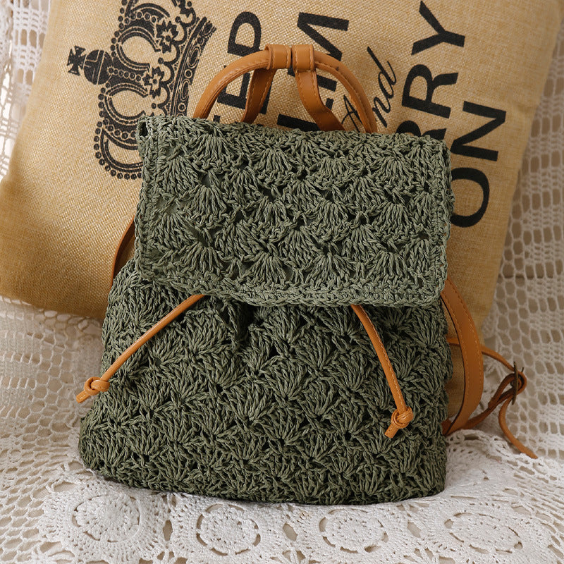 A green Resort Holiday Straw Woven Beach Bag by Beachy Cover Ups sitting on a table.