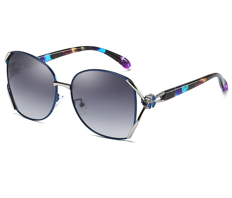A pair of Beachy Cover Ups Polarized Anti-UV Color Tinted Sunglasses with a blue frame and purple accents.