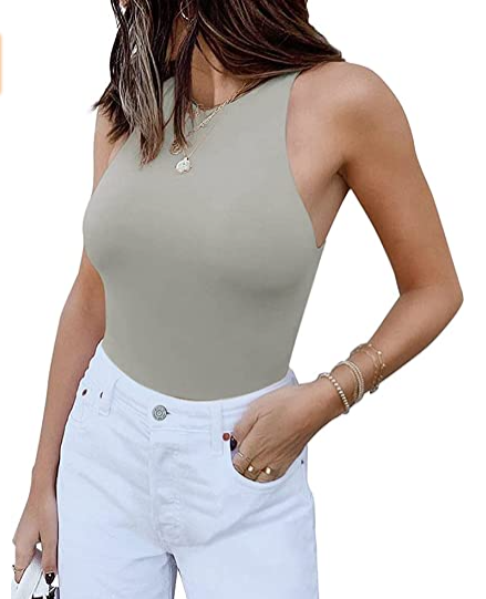 A woman wearing a Sleeveless Halter Neck Tank Top by Beachy Cover Ups and white jeans.
