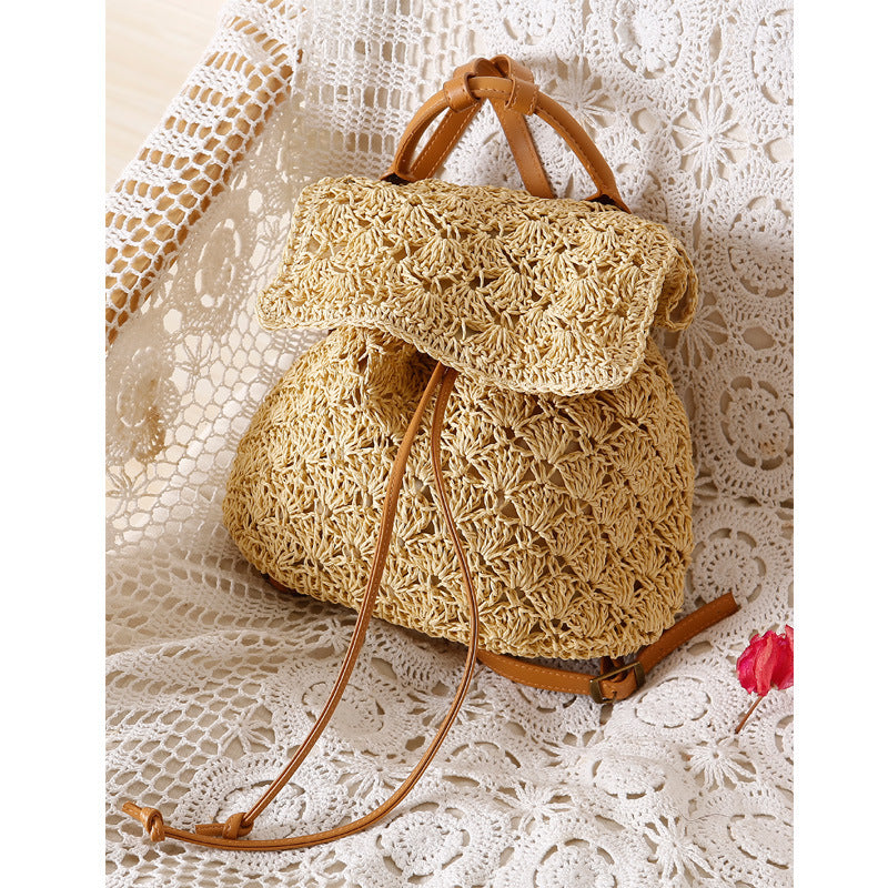 A small Resort Holiday Straw Woven Beach Bag by Beachy Cover Ups on a lace doily perfect for a resort holiday.