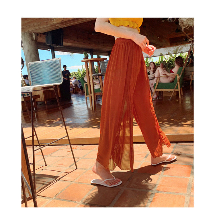 A woman in a Beachy Cover Ups Wavy Three-piece Beach Swimsuit and Beach Pants walking on a tiled floor.