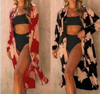 A woman in a Elegant Floral Beach Kimono Cover Up by Beachy Cover Ups.