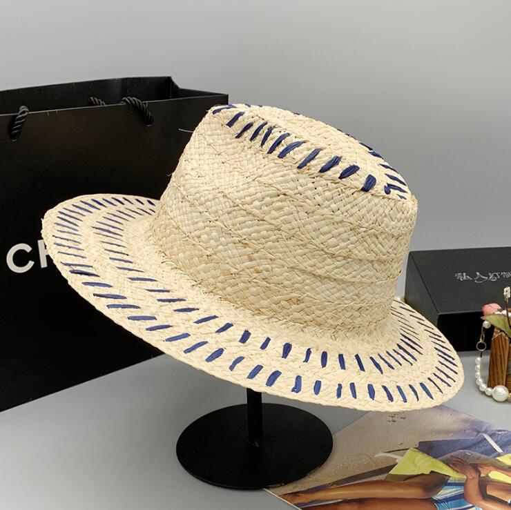 A Summer Tiny Stripes Straw Hat on a stand made by Beachy Cover Ups.