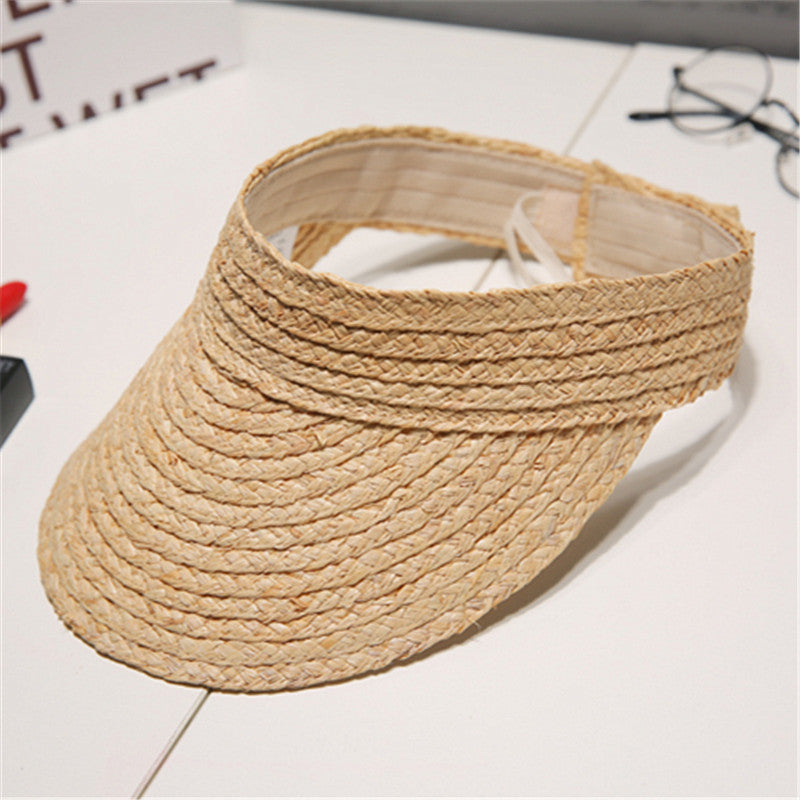 A Beachy Cover Ups Beach Woven Straw Sun Visor providing sun protection.