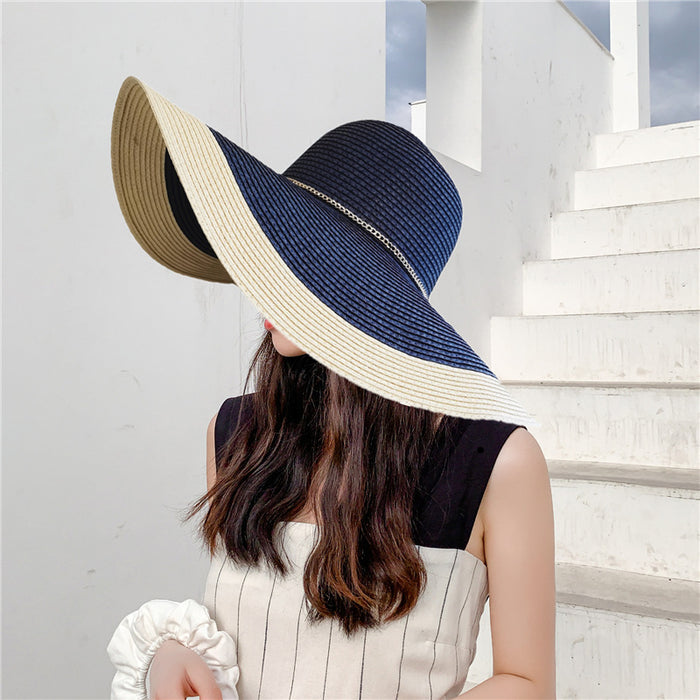 A woman wearing a Beachy Cover Ups Gold Chain Big Brim Beach Hat.