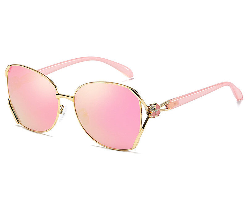 A pair of Polarized Anti-UV Color Tinted Sunglasses by Beachy Cover Ups with gold accents.