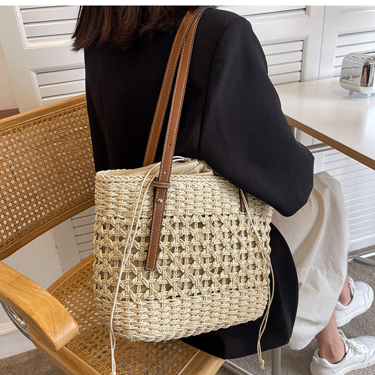 A woman embracing Beachy Cover Ups beach fashion with a Beach Fashion Woven Shoulder Bag.