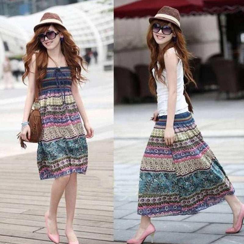 Woman wearing a Beachy Cover Ups strapless beach holiday Midi boho dress and hat on a beach holiday.