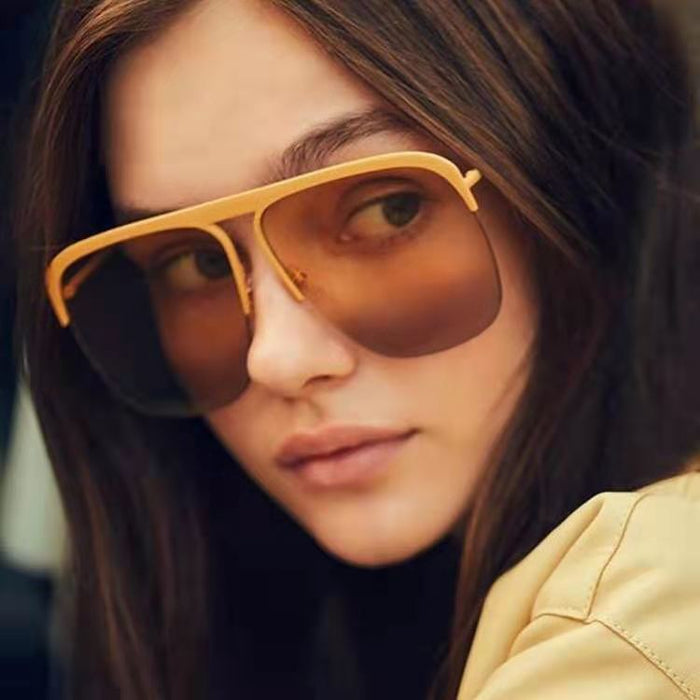 A stylish woman in Beachy Cover Ups Large Half Frame Sunglasses is posing for a photo.