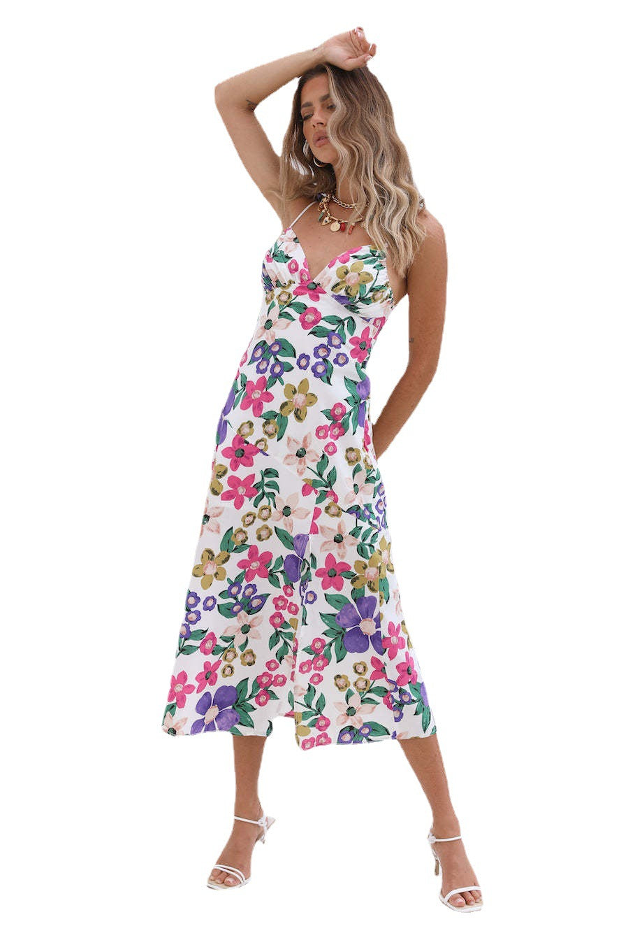 A woman wearing a Floral Summer Halter Slit Dress by Beachy Cover Ups.