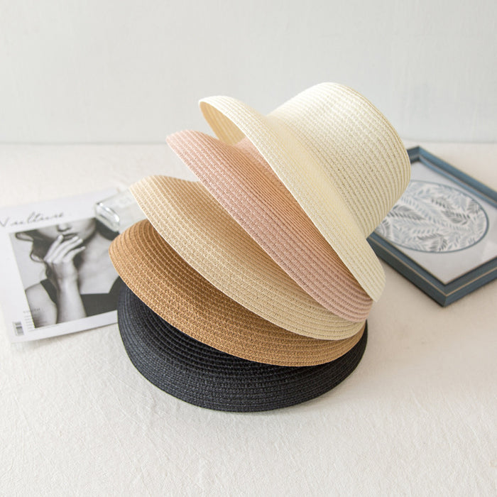 Four different Mid Brim Beach Flat Top Hats by Beachy Cover Ups on top of a white table.