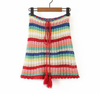 A Rainbow Crochet Bohemian Beach Bikini Two Piece Set hanging on a wooden hanger with a Beachy Cover Ups vibe.