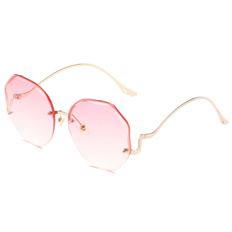 A pair of Beachy Cover Ups Irregular Shaped Rimless Cut Edge Sunglasses.
