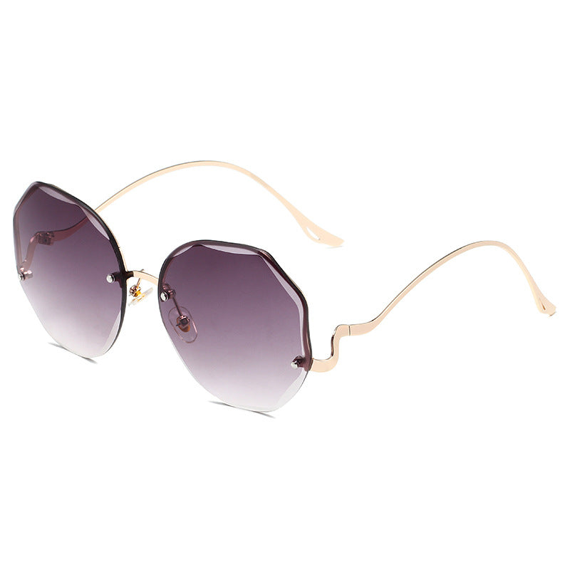 Beachy Cover Ups Irregular Shaped Rimless Cut Edge Sunglasses with gold frame and purple lenses.