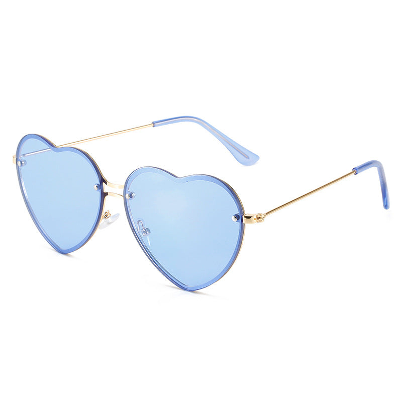 A pair of Beachy Cover Ups Heart Shaped Rimless Sunglasses, perfect for fashion-forward festive occasions.