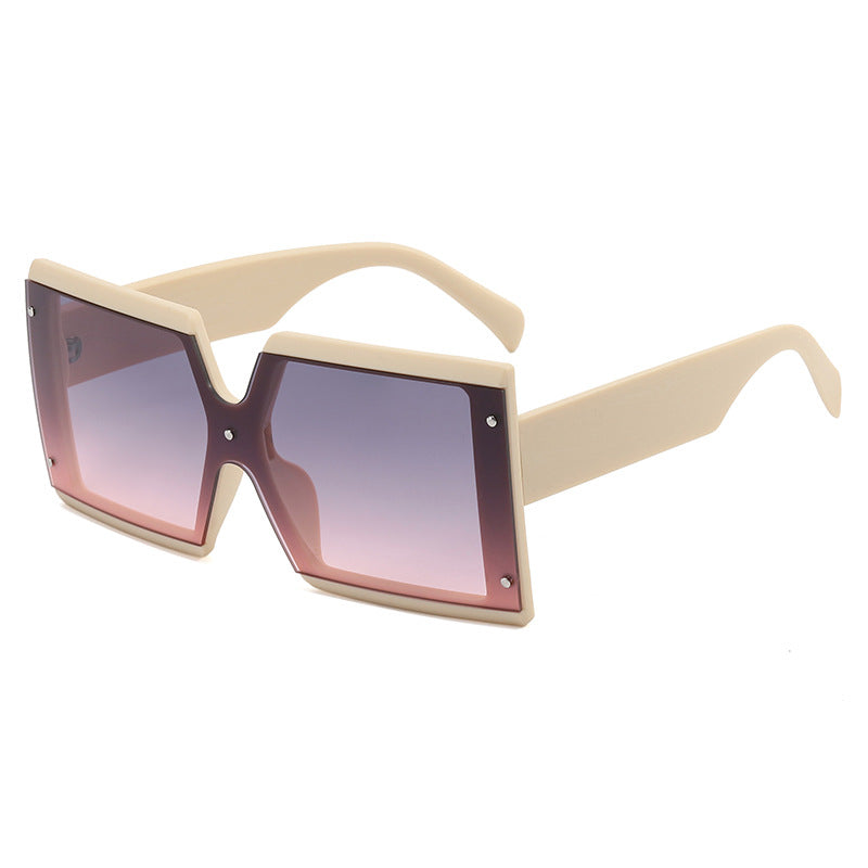 A pair of Beachy Cover Ups retro square sunglasses with pink lenses.