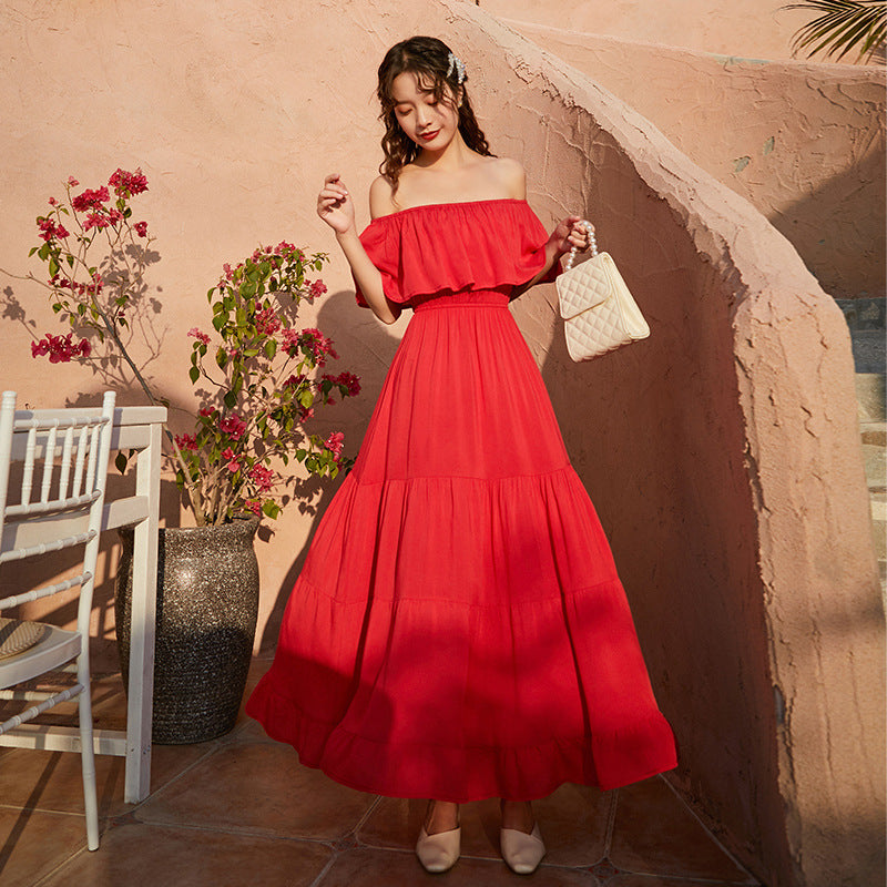 A woman wearing a Beachy Cover Ups one-shoulder beach umbrella dress.