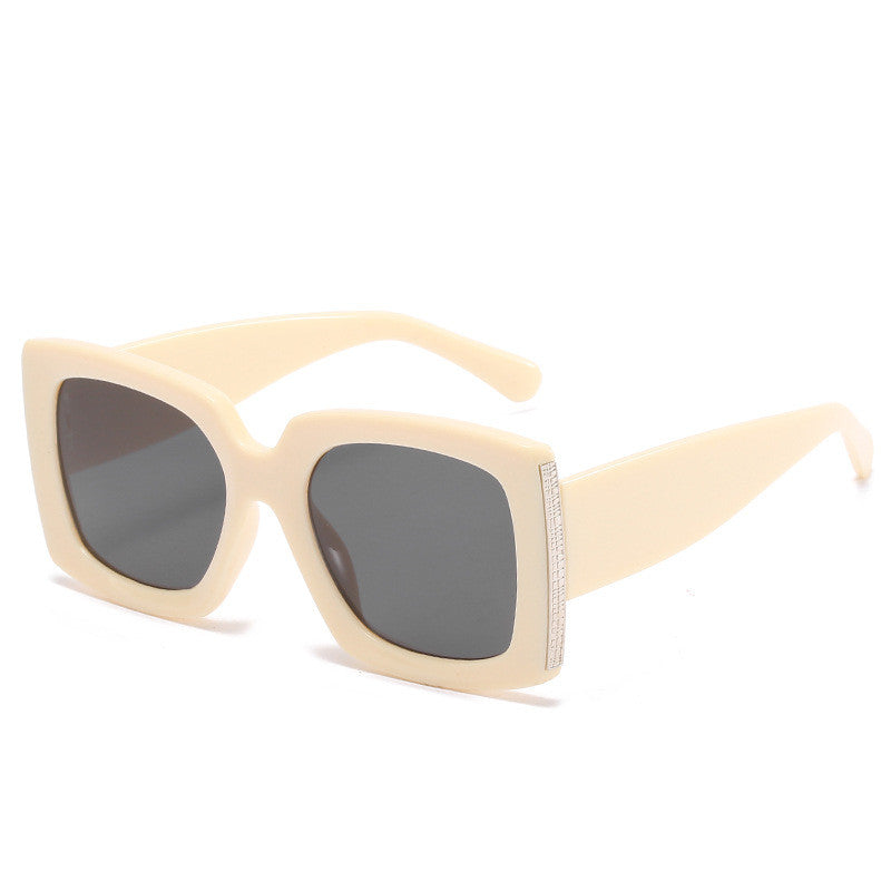 A pair of Trendy Large Frame Sunglasses with silver lenses by Beachy Cover Ups.