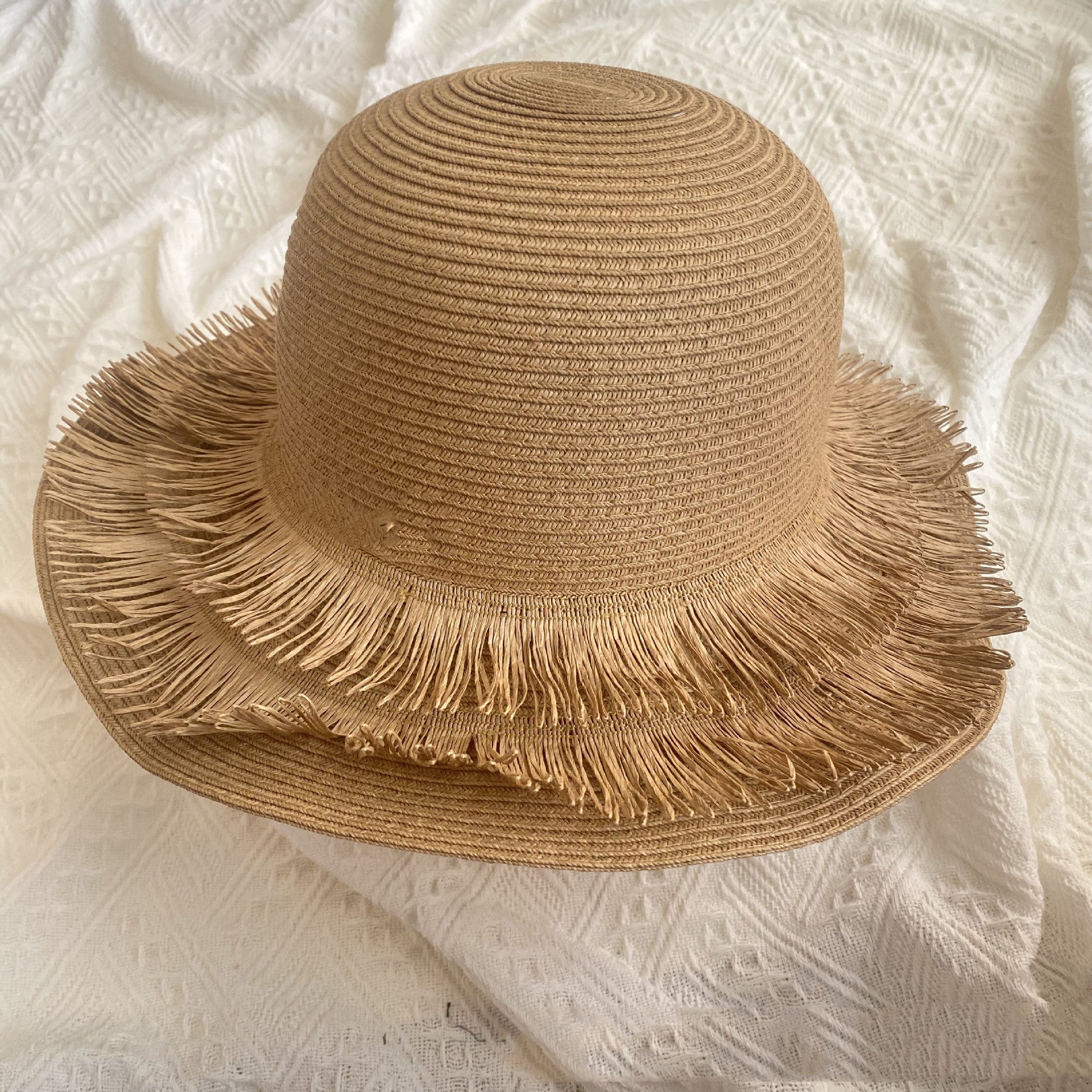 A Fringed Designed Seaside Beach Straw Hat by Beachy Cover Ups, perfect for sun protection, with fringes for added finesse.