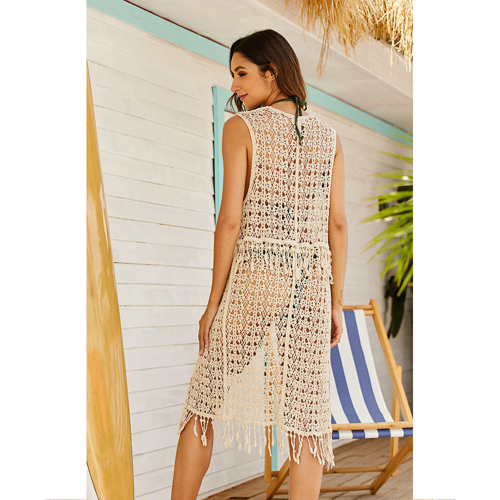 A woman wearing a Summer Net Knitted Beachy Cover Up Vest by Beachy Cover Ups with boho charm on the beach.