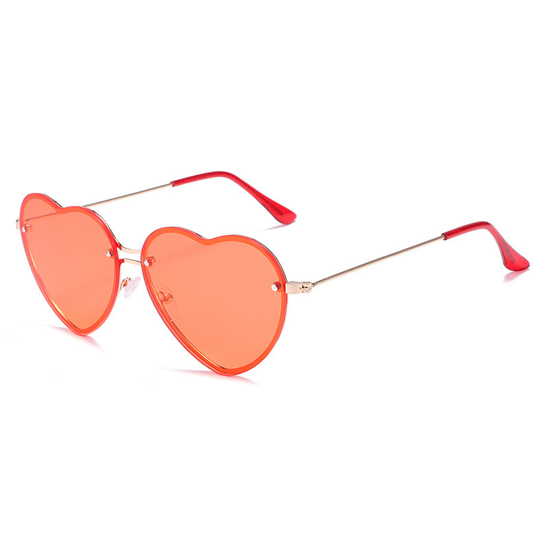 A pair of Beachy Cover Ups Heart Shaped Rimless Sunglasses, perfect for festive occasions.