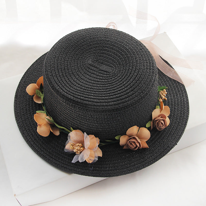 A Flower Designed Beach Hat by Beachy Cover Ups adorned with flowers.